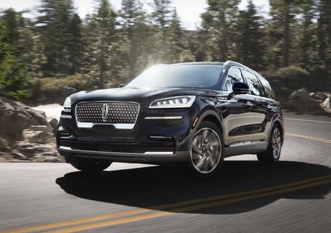 A Lincoln Aviator® SUV is being driven on a winding mountain road | Vista Lincoln Woodland Hills in Woodland Hills CA