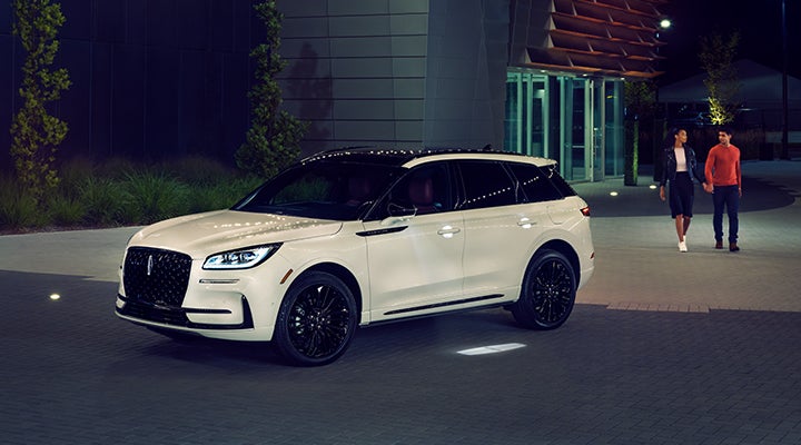 Two people approach a 2024 Lincoln Corsair® SUV featuring the available Jet Appearance Package. | Vista Lincoln Woodland Hills in Woodland Hills CA