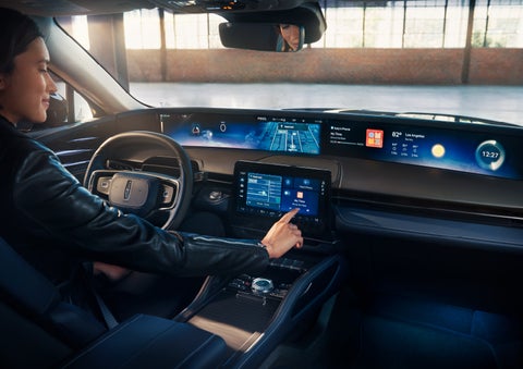 The driver of a 2024 Lincoln Nautilus® SUV interacts with the center touchscreen. | Vista Lincoln Woodland Hills in Woodland Hills CA