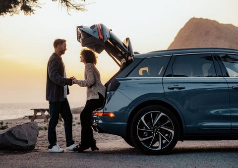 A couple share a moment together outside a 2025 Lincoln Corsair® SUV near the open liftgate. | Vista Lincoln Woodland Hills in Woodland Hills CA