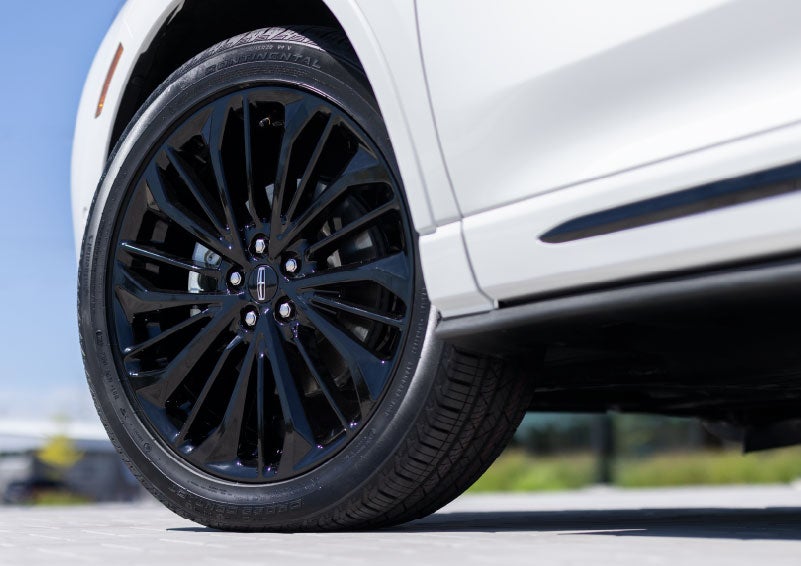 A stylish 20-inch black aluminum wheel of the available Jet Appearance Package is shown. | Vista Lincoln Woodland Hills in Woodland Hills CA