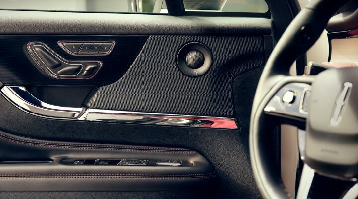 A Revel® audio speaker is shown in the driver's side door of a 2025 Lincoln Corsair® SUV. | Vista Lincoln Woodland Hills in Woodland Hills CA