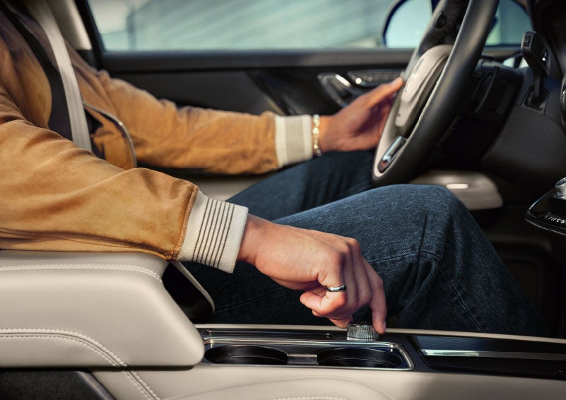 The driver of a 2024 Lincoln Corsair® SUV is shown selecting the drive mode. | Vista Lincoln Woodland Hills in Woodland Hills CA