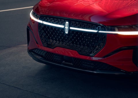 The available front LED light bar and center Lincoln Star logo glow at dusk. | Vista Lincoln Woodland Hills in Woodland Hills CA