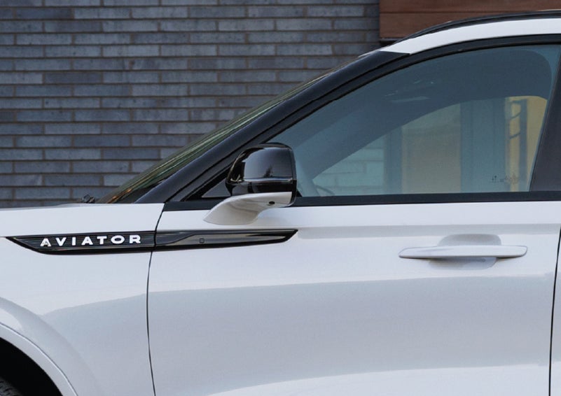 The driver’s side door and fender badging of a white 2026 Lincoln Aviator® SUV are showcased. | Vista Lincoln Woodland Hills in Woodland Hills CA