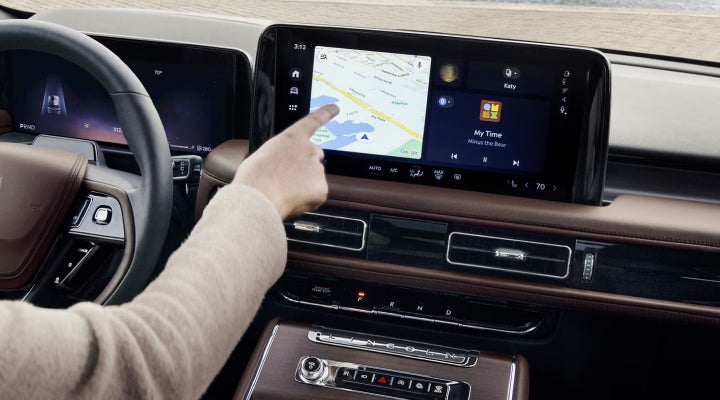 A person is tapping the center display touchscreen of a 2026 Lincoln Aviator® SUV. | Vista Lincoln Woodland Hills in Woodland Hills CA