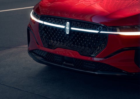 The available front LED light bar and center Lincoln Star logo glow at dusk. | Vista Lincoln Woodland Hills in Woodland Hills CA