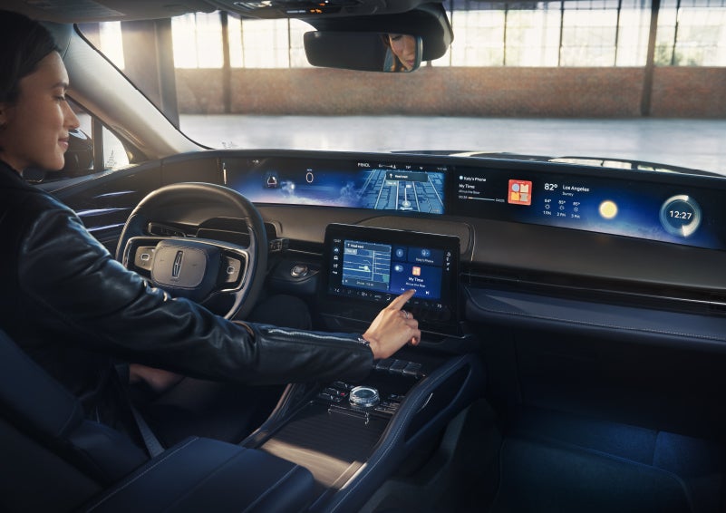 The driver of a 2026 Lincoln Nautilus® SUV interacts with the center touchscreen. | Vista Lincoln Woodland Hills in Woodland Hills CA
